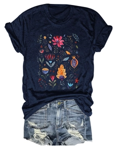 Detail of navy T-shirt with floral print and distressed denim shorts with frayed edges