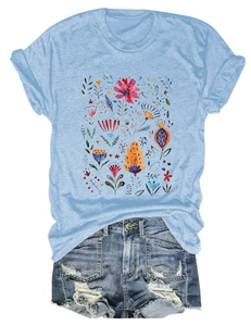 Flat lay of light blue floral t-shirt with distressed denim shorts on white background