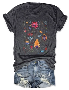 Close-up of floral watercolor print on a grey crew neck t-shirt with denim shorts