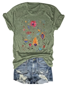Detailed flat lay of green T-shirt with floral print and ripped denim shorts for women