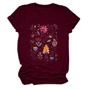 Detail of the colorful floral folk art print on a burgundy crewneck short sleeve T-shirt