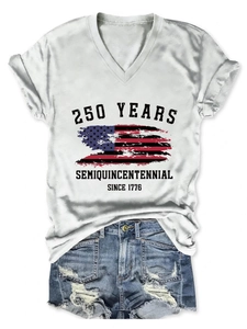Flat lay of a white V-neck T-shirt with 250 Years US flag print and ripped denim shorts