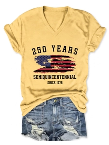 Flat lay of yellow V-neck tee with 250 years American flag print and denim shorts