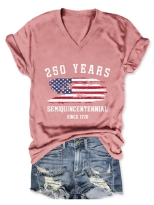 Flat lay of pink V-neck T-shirt with 250 Years Semiquincentennial print and denim shorts