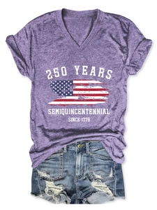 Detail of purple V-neck T-shirt with 250 years anniversary print and ripped denim shorts