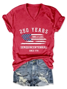 Flat lay of a red V-neck T-shirt with 250 years Semiquincentennial print and denim shorts