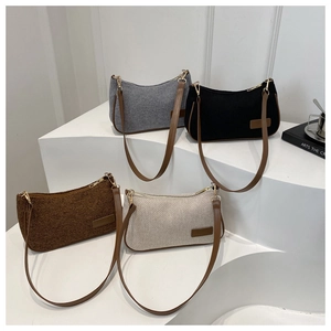 Detail view of woven shoulder bags in four vintage colors on minimalist white steps