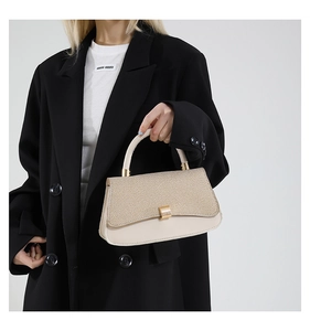 Detail of elegant beige crossbody bag showing woven texture and smooth leather finish