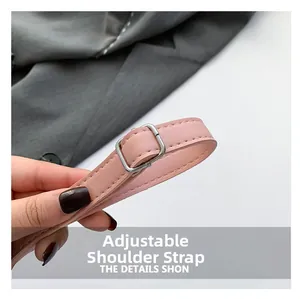 Macro shot of adjustable pink PU leather shoulder strap with silver metal buckle detail