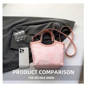 Detailed top view of a pink silk embroidery bucket bag with elegant cloud patterns