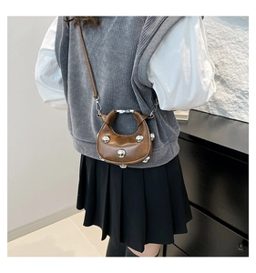 Brown half-moon crossbody bag with silver studs and polished leather finish