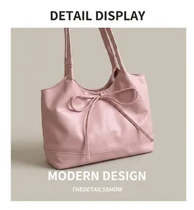 Detail of pink PU leather tote featuring a stylish bow decoration and stitching