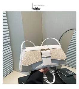 Close-up of white crocodile embossed texture and gold buckle on stylish shoulder bag