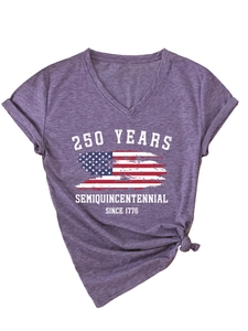 Close-up of Semiquincentennial graphic print and knotted hem on purple V-neck t-shirt