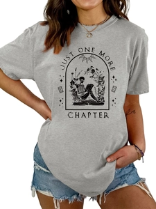 Detail of grey crewneck tee featuring skeleton reading among flowers with text illustration