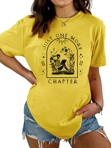 Detail of Just One More Chapter graphic on a yellow cotton t-shirt with skeleton reader print