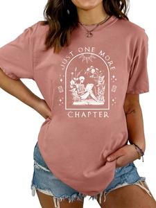 Detail of Just One More Chapter print on dusty rose cotton t-shirt with skeleton reader