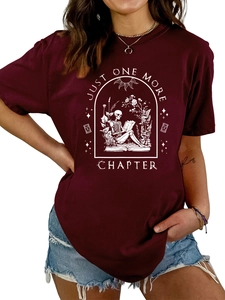 Detail of burgundy t-shirt with skull reading graphic and JUST ONE MORE CHAPTER text