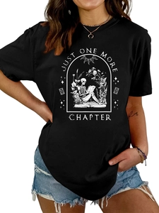 Close-up of skeleton reading print on black cotton t-shirt with Just One More Chapter text