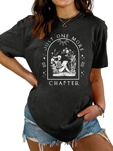 Detail of Just One More Chapter graphic print on a black loose cotton t-shirt