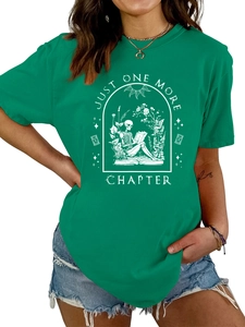 Detail of green cotton T-shirt featuring a skeletal reader and Just One More Chapter slogan