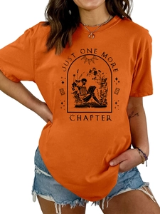 Detail of Just One More Chapter print on orange cotton t-shirt with skull and book graphic