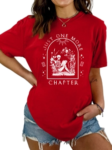 Close-up of red cotton T-shirt featuring white skeleton reading book graphic detail