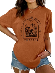 Close-up of skeleton reading design and Just One More Chapter text on burnt orange tee
