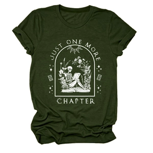 Flat lay of dark green t-shirt featuring skeleton reading floral book art and quote