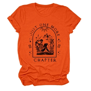Close-up of orange t-shirt featuring gothic skull reading a book and text Just One More Chapter