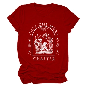 Close-up of skeleton reading on books print and Just One More Chapter text on red tee
