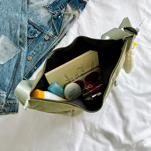 Sage green crescent bag showing large interior capacity for daily essentials
