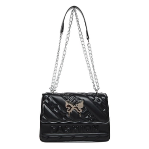 Black quilted crossbody bag with silver butterfly buckle and chain strap on white background