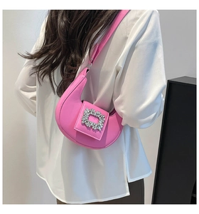 Detail of pink crescent shoulder bag with sparkling rectangular rhinestone buckle