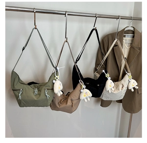 Selection of crescent nylon crossbody bags in four colors with plush cloud charms