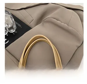 Detailed close-up of premium faux leather tote bag with fine stitching and soft handles