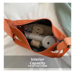 Internal view of the orange nylon crescent bag showing high capacity for daily essentials
