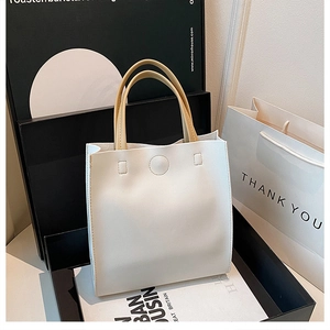 Vue détaillée du sac cabas en cuir synthétique blanc crème avec coutures et bouton