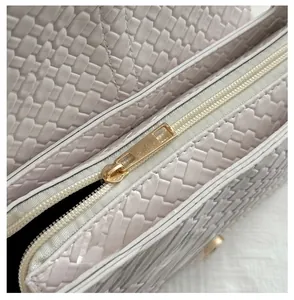 Detailed macro view of woven texture material and premium smooth gold metal zipper