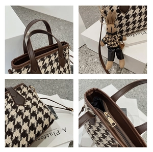 Detail of houndstooth handbag featuring a cute rabbit charm and brown leather trim