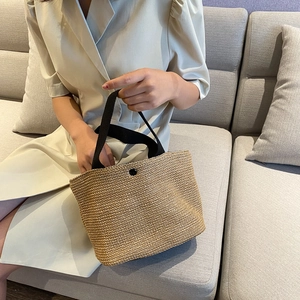 Women's straw woven handbag with black handles for summer beach vacations and daily leisure