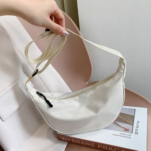 Minimalist white nylon crescent crossbody bag with adjustable strap for daily commute