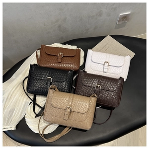 Detail showing various colors of snake pattern textured PU leather crossbody bags