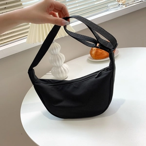 Minimalist black nylon crescent crossbody bag with adjustable strap for daily use