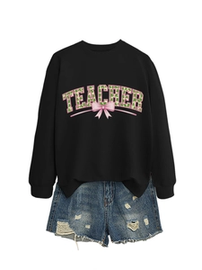 Close-up of black sweatshirt with floral TEACHER lettering and pink bow design