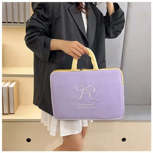 Close-up of purple laptop bag featuring white butterfly embroidery and contrasting handles