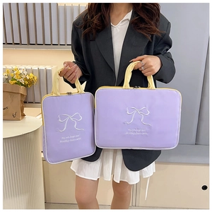 Detail of lavender and yellow embroidered butterfly laptop bags with dual handles