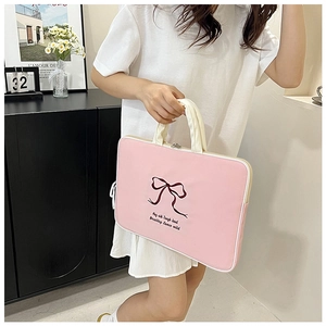 Detailed embroidery of a red bow and text on a pink aesthetic laptop tote bag