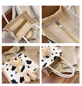 Detail view of canvas tote featuring cute plush bear, cow print, and sturdy rope handle