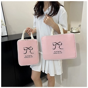 Detail of pink embroidered butterfly laptop bags in two sizes with dual zippers and handles